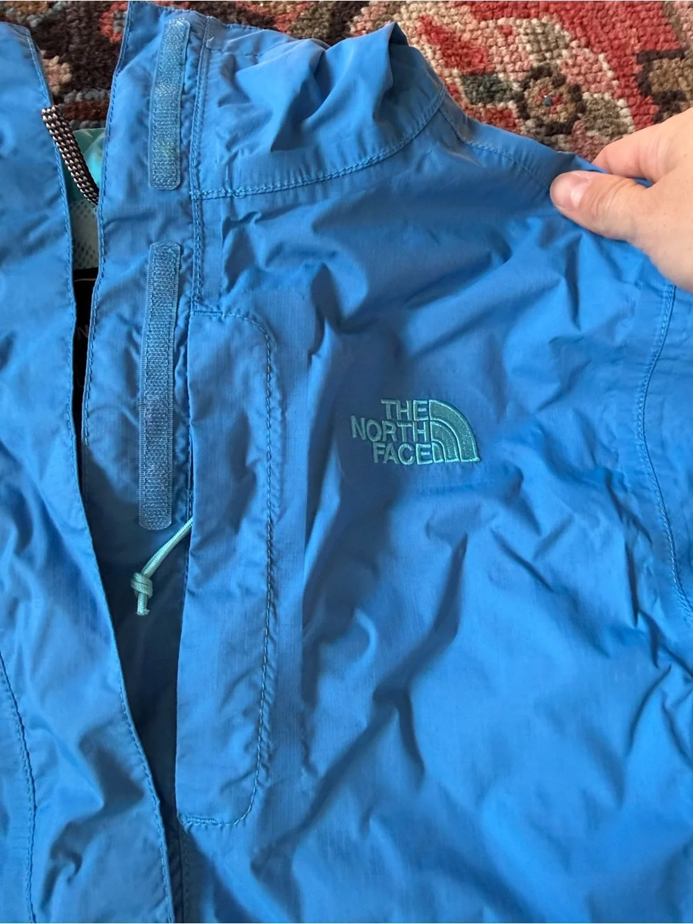 The North Face Women’s Blue and Aqua Hooded Rain Jacket